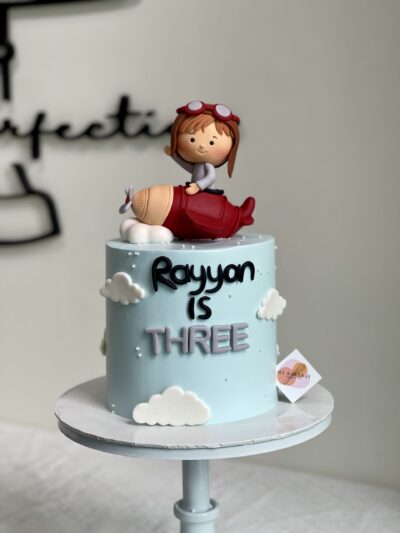 Rayyan's Baby Boy on Red Airplane Cake